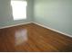 Bedroom with light walls and hardwood floors featuring a window letting in natural light at 811 Rogers Rd., Myrtle Beach, SC 29577