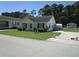 Well-maintained single-story home with green lawn, storage building, and paved driveway at 811 Rogers Rd., Myrtle Beach, SC 29577