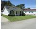 Neat single-story home with a green lawn and simple landscaping, featuring a cozy porch at 811 Rogers Rd., Myrtle Beach, SC 29577