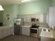Modern kitchen with stainless steel appliances, gray cabinetry, and quartz countertops at 811 Rogers Rd., Myrtle Beach, SC 29577