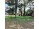 Green backyard features a waterfront view with mature trees providing shade and a tranquil atmosphere at 903 23Rd Ave. N, North Myrtle Beach, SC 29582