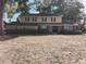 Traditional two-story home featuring a symmetrical facade, classic shutters, and a landscaped front yard with mature trees at 903 23Rd Ave. N, North Myrtle Beach, SC 29582