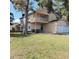 This lovely home boasts an attached two-car garage, a second-story balcony, and a lush green lawn with mature trees at 903 23Rd Ave. N, North Myrtle Beach, SC 29582