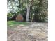 A charming wooden shed nestled in a backyard, surrounded by lush greenery and mature trees, providing storage space at 903 23Rd Ave. N, North Myrtle Beach, SC 29582