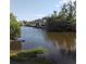 A serene view of the calm water surrounded by lush trees and nearby houses, creating a peaceful natural setting at 903 23Rd Ave. N, North Myrtle Beach, SC 29582
