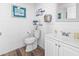 Bathroom featuring a toilet, vanity, mirror, and beach-themed decorations at 920 N Waccamaw Dr. # 2102, Murrells Inlet, SC 29576