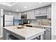 Modern kitchen boasts gray cabinetry, stainless steel appliances, and a large island with seating at 920 N Waccamaw Dr. # 2102, Murrells Inlet, SC 29576