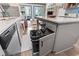Stylish kitchen with island, gray cabinets, quartz countertop and easy access to living and dining area at 920 N Waccamaw Dr. # 2102, Murrells Inlet, SC 29576