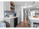 Spacious kitchen with stainless steel wine cooler, gray cabinets, open shelving, and quartz countertops at 920 N Waccamaw Dr. # 2102, Murrells Inlet, SC 29576