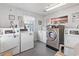 On-site laundry room featuring multiple washers and dryers with natural light and beach-themed decor at 920 N Waccamaw Dr. # 2102, Murrells Inlet, SC 29576
