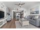 Bright open-concept living room with a comfortable couch, chair, and modern kitchen with counter seating at 920 N Waccamaw Dr. # 2102, Murrells Inlet, SC 29576