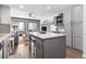 An open concept living space with a kitchen featuring an island, stainless appliances and balcony access at 920 N Waccamaw Dr. # 2102, Murrells Inlet, SC 29576