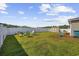 Green backyard with colorful Adirondack chairs surrounding a fire pit and a storage shed at 924 Akron St., Conway, SC 29526