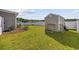 Well-maintained backyard with a storage shed, tool bench, and green lawn at 924 Akron St., Conway, SC 29526
