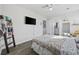 Bright bedroom featuring a mounted TV, ladder shelf, and access to an ensuite bathroom at 924 Akron St., Conway, SC 29526