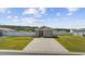 Wide view of a charming single-story home with landscaped yard, long concrete driveway and white fence at 924 Akron St., Conway, SC 29526