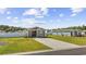 Wide angle view of a single-story home with landscaped yard, long concrete driveway and white fence at 924 Akron St., Conway, SC 29526