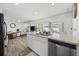 Kitchen island with sink, stainless steel dishwasher, and view of living area at 924 Akron St., Conway, SC 29526
