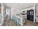 Open kitchen with island seating, stainless steel appliances, white cabinets, and hardwood flooring at 924 Akron St., Conway, SC 29526
