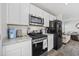 Well-equipped kitchen with black refrigerator, stainless steel microwave, and updated appliances at 924 Akron St., Conway, SC 29526