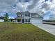 Charming two-story home with a manicured lawn and attached two-car garage at 9409 Long Meadow Way, Longs, SC 29568