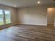 Bright living room featuring large windows with a view of a serene lake at 9409 Long Meadow Way, Longs, SC 29568