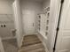 Mudroom with built in shelving, coat hooks, and bench at 9409 Long Meadow Way, Longs, SC 29568