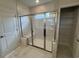 Bathroom featuring a glass enclosed shower with marble tile and built in bench at 9409 Long Meadow Way, Longs, SC 29568