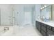 Luxurious bathroom with double vanity, standalone tub, and frameless glass shower at 9419 Long Meadow Way, Longs, SC 29568