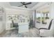 Bright home office with custom built-ins, modern decor, and a stylish ceiling fan at 9419 Long Meadow Way, Longs, SC 29568