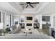 Stylish living room featuring fireplace, coffered ceilings and adjacent wet bar at 9419 Long Meadow Way, Longs, SC 29568