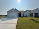 Inviting single-story home boasts lush green grass and concrete driveway at 1000 Lady Bird Way, North Myrtle Beach, SC 29582