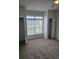 A bright bedroom with neutral walls, carpet, large window, and dual closets at 102 Scotch Broom Dr. # B-204, Little River, NC 29566