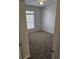 A light filled bedroom with neutral walls, carpet, and a large window at 102 Scotch Broom Dr. # B-204, Little River, NC 29566