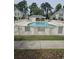 Fenced community pool surrounded by lounge chairs and manicured lawns, perfect for relaxation at 102 Scotch Broom Dr. # B-204, Little River, NC 29566