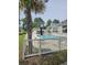 Community pool and lounge area for residents, framed by a mature palm tree at 102 Scotch Broom Dr. # B-204, Little River, NC 29566