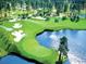 Scenic golf course with lush green fairways, sandy bunkers, and a tranquil water feature at 102 Scotch Broom Dr. # B-204, Little River, NC 29566