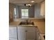 Open kitchen sink overlooking the living room and outdoor patio at 102 Scotch Broom Dr. # B-204, Little River, NC 29566
