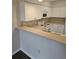 White kitchen cabinets with gray countertops and tile backsplash at 102 Scotch Broom Dr. # B-204, Little River, NC 29566