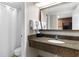 Bathroom with a granite vanity, mirror, and a shower with curtain at 1105 S Ocean Blvd. # 110, Myrtle Beach, SC 29577
