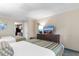 Bright bedroom featuring two beds, dresser with television, and access to the kitchen at 1105 S Ocean Blvd. # 110, Myrtle Beach, SC 29577