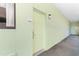 Hallway view that leads to unit 110, complimented with a neutral colored walls and carpeted floors at 1105 S Ocean Blvd. # 110, Myrtle Beach, SC 29577