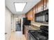 Galley kitchen featuring granite countertops and black appliances at 1105 S Ocean Blvd. # 110, Myrtle Beach, SC 29577