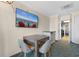 Cozy living area featuring a dining table, chairs, and a wall-mounted television for comfortable relaxation at 1105 S Ocean Blvd. # 110, Myrtle Beach, SC 29577