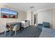 Comfortable living area includes a dining table, chairs, dresser, and wall-mounted television at 1105 S Ocean Blvd. # 110, Myrtle Beach, SC 29577