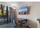 Bright living area featuring a dining table, chairs, and a wall-mounted television for entertainment at 1105 S Ocean Blvd. # 110, Myrtle Beach, SC 29577