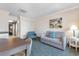 Comfortable living space with a sofa, side chair, dining table and chairs, with a view to the kitchenette at 1105 S Ocean Blvd. # 110, Myrtle Beach, SC 29577
