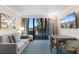 Comfortable living room with a sofa, dining table and chairs, and a sliding glass door to the outdoor balcony at 1105 S Ocean Blvd. # 110, Myrtle Beach, SC 29577