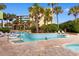 Outdoor pool with a lazy river, hot tub, palm trees and lounge chairs at 1105 S Ocean Blvd. # 110, Myrtle Beach, SC 29577