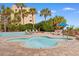 Inviting outdoor pool surrounded by palm trees, sun loungers, and a hot tub at 1105 S Ocean Blvd. # 110, Myrtle Beach, SC 29577
